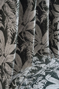 Detailed close-up of dark green tropical palm leaf patterns on thick chenille fabric