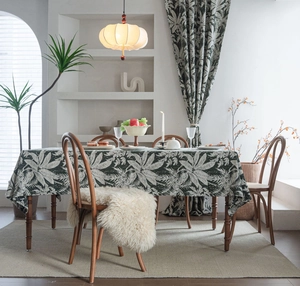Detail of dark green floral pattern jacquard tablecloth with matching curtains