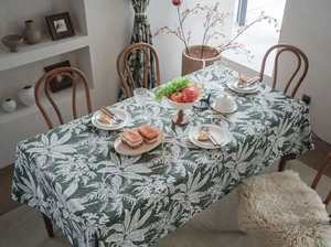 Detail of European retro dark green tablecloth with white tropical palm leaf patterns