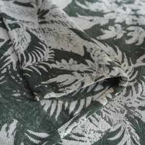 Detail of European vintage dark green floral jacquard tablecloth with thick fabric texture