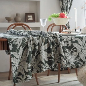 Close-up of vintage dark green tropical leaf pattern on premium jacquard fabric tablecloth