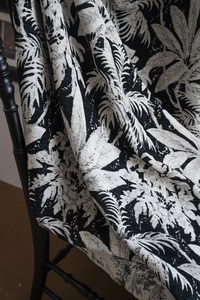 Detail of botanical leaf jacquard pattern on thick black and white chenille fabric drape