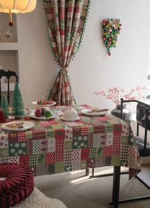 Detail of Christmas jacquard tablecloth with festive gingerbread man and snowflake patterns