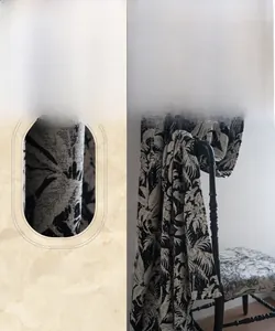 Detail view of black and white botanical embroidery on thick jacquard chenille curtain fabric
