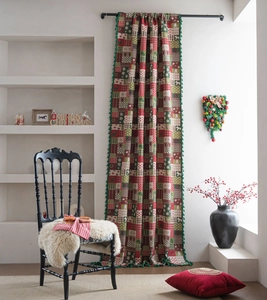 Detail of Christmas plaid curtain with green tassels and festive pattern fabric