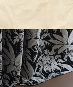 Detail of high-density stitched hem on black and white tropical palm leaf jacquard curtain