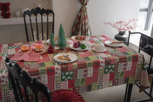 Detailed patchwork Christmas tablecloth featuring gingerbread man and tree festive motifs