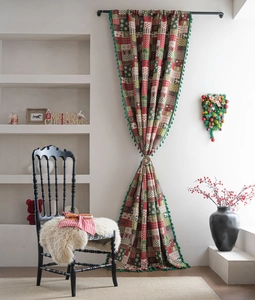 Detailed close-up of Christmas curtains with snowflake elk patterns and green tassels