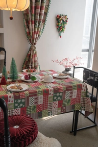 Close-up of Christmas jacquard tablecloth with reindeer, gingerbread man, and plaid patterns
