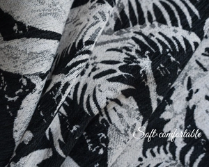Macro detail of tropical black and white chenille jacquard palm leaf curtain fabric