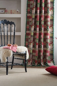 Detailed close-up of Christmas curtains with elk patterns and green fringe tassels