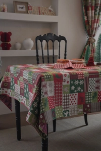 Detail of Christmas tablecloth featuring reindeer, snowflakes and gingerbread patterns