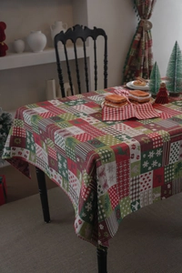 Detail of Christmas tablecloth with gingerbread and reindeer patterns on thick fabric