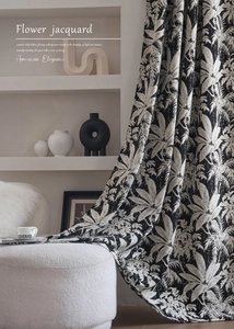Detail of premium black and white tropical leaf jacquard curtain with embossed texture