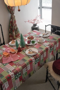 Detailed close-up of Christmas tablecloth featuring gingerbread man and reindeer patterns