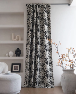 Detail of black and white tropical palm leaf jacquard patterns on blackout chenille curtains