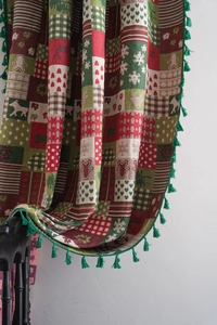 Close-up of woven Christmas jacquard fabric with elk and gingerbread man patterns
