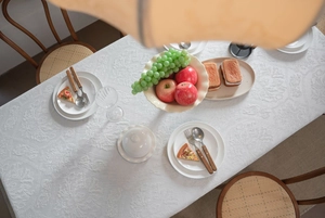 Detailed close-up showing the intricate white floral jacquard pattern on a premium tablecloth