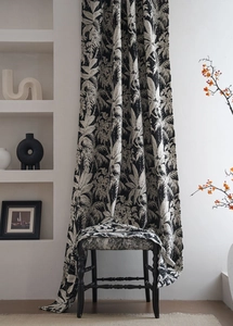 Detail of chenille jacquard curtain fabric with black and white tropical palm leaf patterns