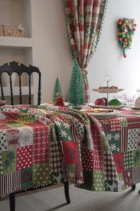 Close-up of festive jacquard tablecloth with Christmas trees, snowflakes and elk patterns