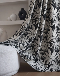 Detail of black and white tropical plant jacquard fabric for blackout curtains with rich texture