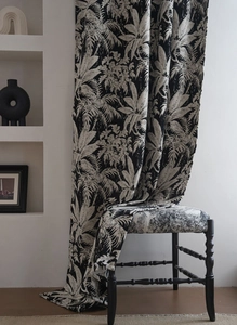 Detail of black and white tropical palm leaf jacquard chenille fabric on a retro chair