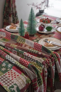 Detailed view of jacquard Christmas tablecloth featuring reindeer and snowflake patterns