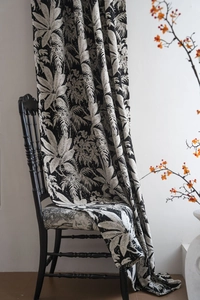 Detail of chenille curtain featuring black palm leaf jacquard pattern and premium texture