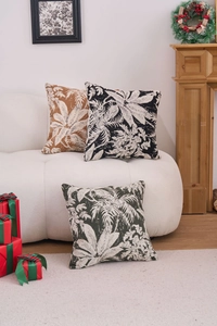 Detailed view of jacquard chenille tropical leaf pattern pillows on a white sofa
