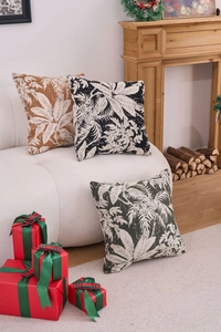 Detail of chenille jacquard throw pillow covers with tropical leaf patterns on a sofa