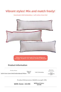 Detailed close-up of solid color linen pillows with decorative shell embroidery edges