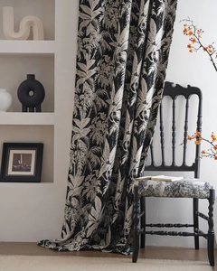 Detailed macro view of black and white tropical floral leaf print on thick chenille fabric
