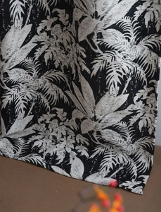 Detail of black and white tropical palm leaf jacquard fabric with thick woven texture