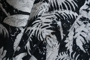 Macro detail of black and white tropical palm leaf jacquard chenille curtain fabric