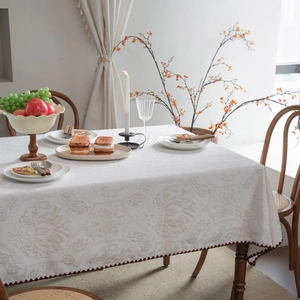 Elegant white floral jacquard tablecloth with embroidered scalloped edges for home decor