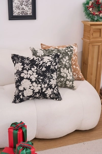 Detailed texture of thick chenille jacquard pillows with white floral patterns on a sofa
