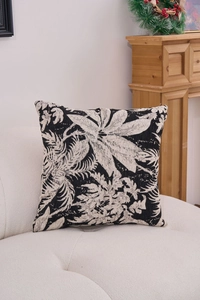 Detail of chenille jacquard cushion cover featuring tropical leaf patterns on a white sofa