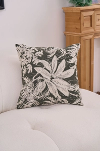 Close-up of chenille jacquard pillow with green tropical leaf pattern on white sofa