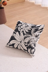 Macro detail of Chenille jacquard fabric showing large black and white plant leaf patterns