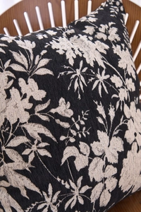 Close-up of Chenille jacquard pillow cover with black and white floral texture on wood chair