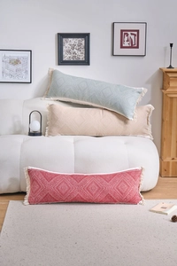 Detail of bohemian jacquard lumbar pillow with geometric patterns and fringe trim