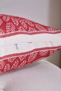 Close-up of a hidden white zipper on red and white jacquard pattern throw pillow fabric