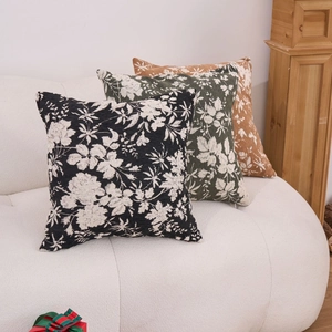 Three premium jacquard chenille throw pillows with vintage floral patterns on a white sofa