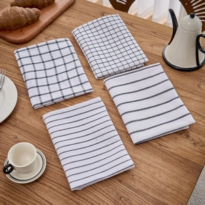 Close-up of Nordic style cotton linen checkered and striped napkins on wooden table
