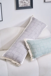Detailed view of jacquard boho pillows with geometric patterns and fringe tassels