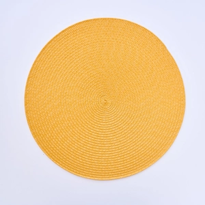 Detailed top view of a yellow round woven heat-resistant PP placemat for dining table decoration
