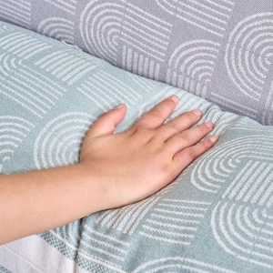 Light blue and grey geometric jacquard bolster pillow showing soft fabric texture