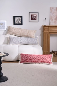 Detailed view of jacquard lumbar pillows with mandala patterns and white fringe trim
