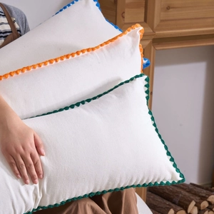 Minimalist embroidered rectangular lumbar pillows with delicate crochet lace borders