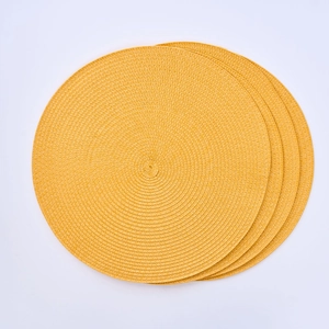 Close-up of four stacked round woven heat-resistant PP placemats in vibrant yellow color